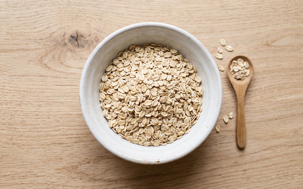 Rolled oat flakes in a white ceramic bowl